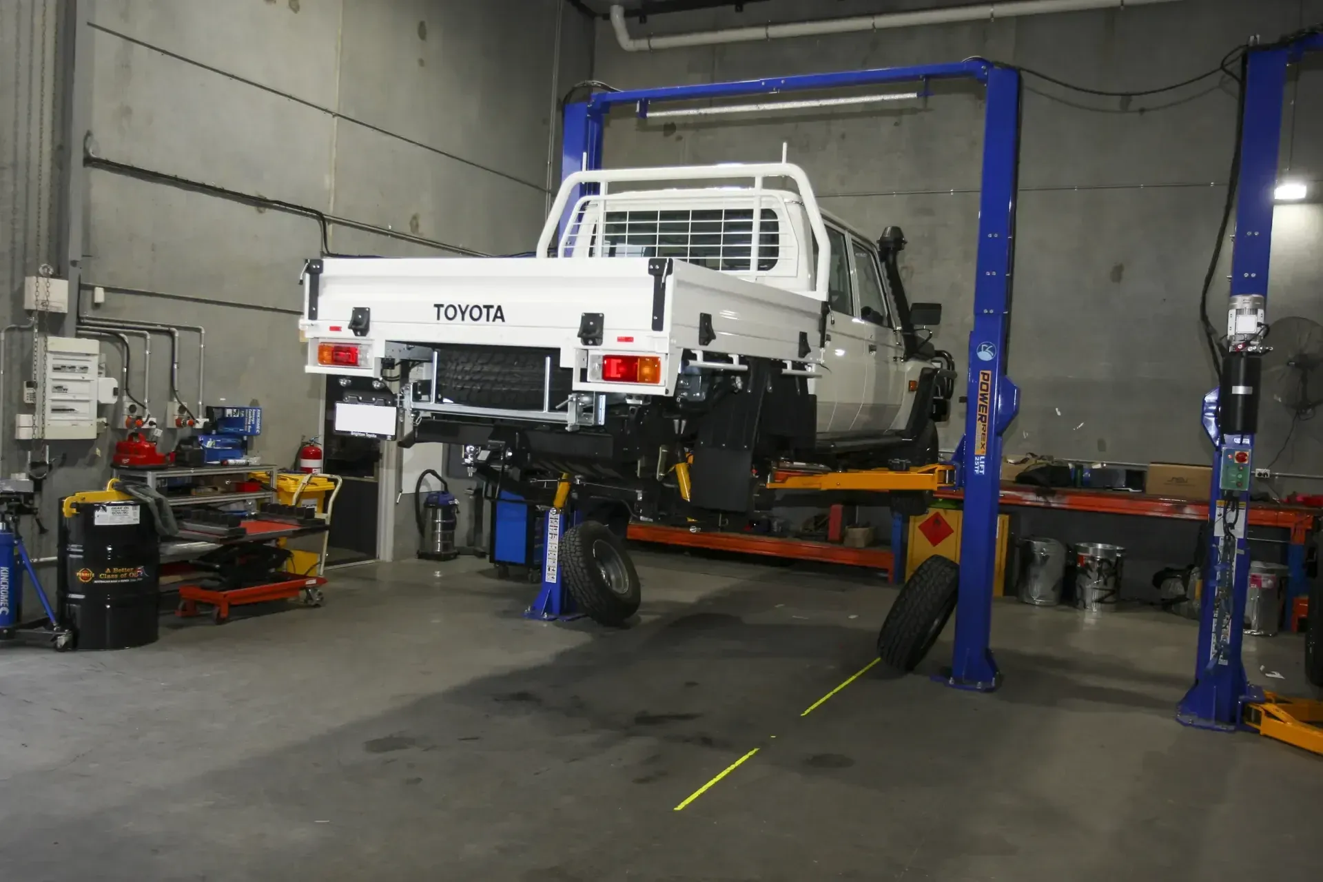 A tray-back 79 Series up on a workshop hoist, the wheels off mid-build.
