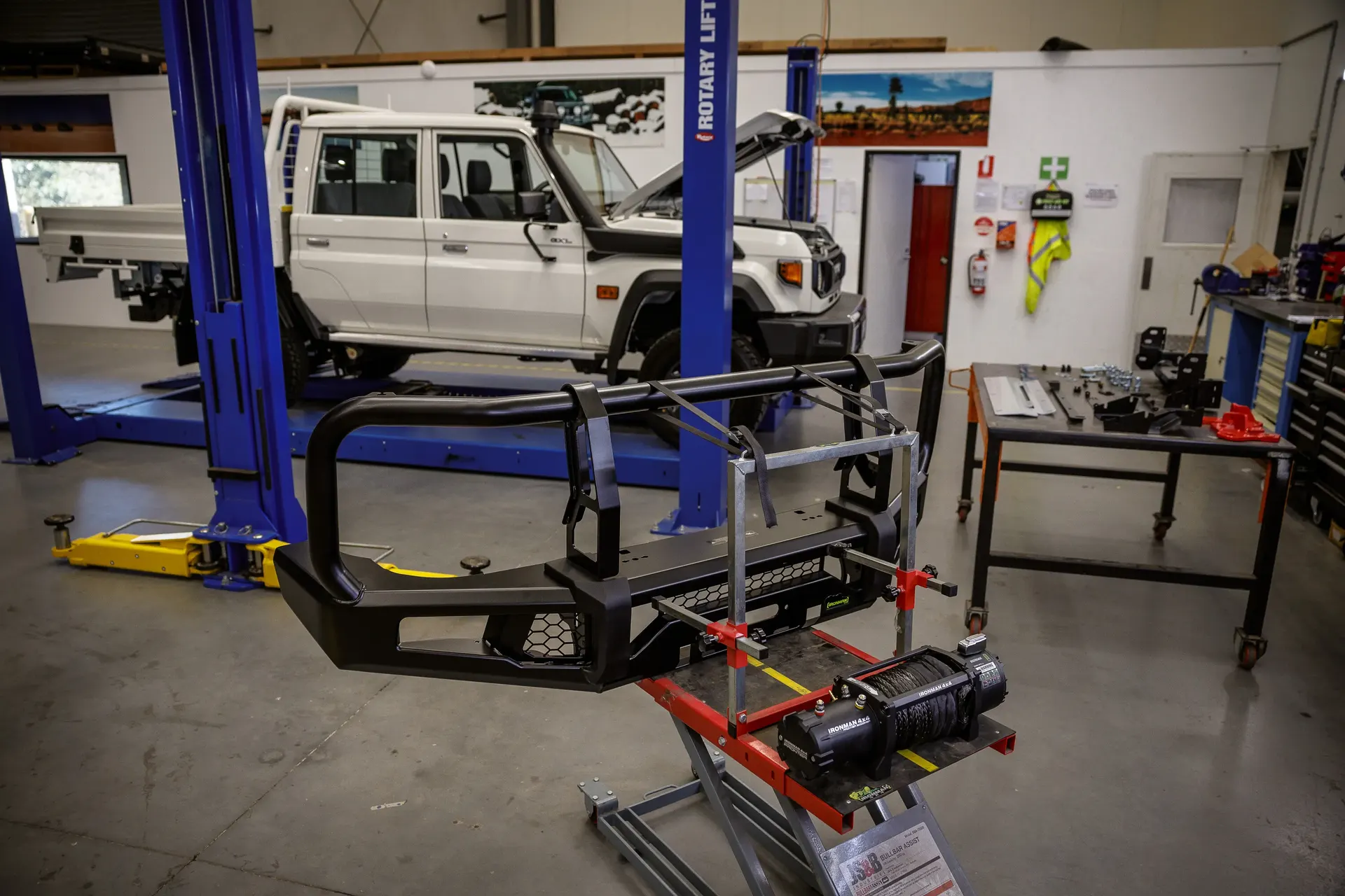 A 79 Series on a workshop hoist, a new bar and winch on the stand in front.